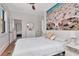 A bedroom featuring a large beach mural, closet, and an ensuite bathroom at 513 W Paris St, Tampa, FL 33604