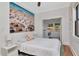 This bedroom features a beach-themed mural, hardwood floors, and a laundry area in the background at 513 W Paris St, Tampa, FL 33604