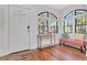 Bright foyer featuring wood floors, a bench seat, and an arched window at 513 W Paris St, Tampa, FL 33604