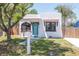 Charming bungalow with a tidy yard, brightly painted door, and eye-catching mailbox at 513 W Paris St, Tampa, FL 33604