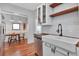Bright kitchen with white cabinets, wood countertops, and stainless steel appliances, leading to dining area at 513 W Paris St, Tampa, FL 33604