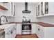 Updated kitchen with white cabinets, wood countertops, stainless steel appliances, and a white subway tile backsplash at 513 W Paris St, Tampa, FL 33604