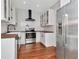 Bright kitchen with white cabinets, stainless steel appliances, and modern fixtures at 513 W Paris St, Tampa, FL 33604