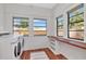 A well-lit laundry room with wooden countertops, bright windows, and washer dryer at 513 W Paris St, Tampa, FL 33604