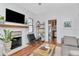 Comfortable living room features wood floors, a brick fireplace, and stylish decor at 513 W Paris St, Tampa, FL 33604
