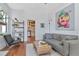 Cozy living room with wood floors, comfortable sofa, and views into the kitchen at 513 W Paris St, Tampa, FL 33604