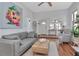 Open-concept living room with modern furnishings, wood floors, and lots of natural light at 513 W Paris St, Tampa, FL 33604