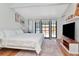 Primary bedroom with a large bed, stylish area rug, windows with natural light, and modern furnishings at 513 W Paris St, Tampa, FL 33604