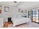 Bright bedroom with white walls, a large bed, an area rug, and access to a patio at 513 W Paris St, Tampa, FL 33604