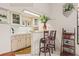 Charming bar area featuring custom cabinetry, a built-in sink, and comfortable seating for entertaining at 5434 Wellfield Rd, New Port Richey, FL 34655