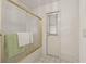 Bathroom showcasing a shower with frosted glass door and an access door at 5434 Wellfield Rd, New Port Richey, FL 34655