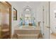 Bright bathroom featuring a soaking tub with custom stained glass windows and a separate shower at 5434 Wellfield Rd, New Port Richey, FL 34655