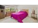 Cozy bedroom with a large window, dresser, and closet space at 5434 Wellfield Rd, New Port Richey, FL 34655