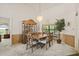 Cozy dining area featuring a stylish chandelier, classic wooden furniture, and natural light at 5434 Wellfield Rd, New Port Richey, FL 34655