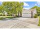 Lovely single-Gathering home featuring a spacious driveway, a manicured lawn, and an attached two-car garage at 5434 Wellfield Rd, New Port Richey, FL 34655
