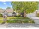 Charming single-story home featuring a well-maintained lawn and a large tree providing ample shade at 5434 Wellfield Rd, New Port Richey, FL 34655