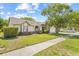 Charming one-story home featuring a well-maintained lawn, mature landscaping, and an attached two-car garage at 5434 Wellfield Rd, New Port Richey, FL 34655
