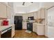 Charming kitchen features classic white cabinets and modern appliances with a view into the adjacent living room at 5434 Wellfield Rd, New Port Richey, FL 34655