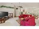 Inviting living room with a red sectional sofa, open layout, and stylish decor throughout the space at 5434 Wellfield Rd, New Port Richey, FL 34655