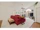 Bright living room featuring comfortable red sofas, modern ceiling fan, and decorative wall decor at 5434 Wellfield Rd, New Port Richey, FL 34655