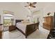 Cozy main bedroom with a comfortable bed, side tables, and a private access to the outdoor space at 5434 Wellfield Rd, New Port Richey, FL 34655