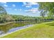 Scenic view of the large pond with lush green banks and tree line at 5434 Wellfield Rd, New Port Richey, FL 34655