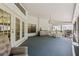 Spacious outdoor porch featuring tile floors and dining area with seating at 5434 Wellfield Rd, New Port Richey, FL 34655