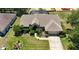 Spacious home with a well-kept lawn, mature landscaping, and a long driveway leading to the attached garage at 5465 Chestnut Ridge Rd, Dade City, FL 33523