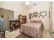 Cozy bedroom featuring carpeted floors, a ceiling fan, and a queen sized bed with an American flag throw pillow at 5465 Chestnut Ridge Rd, Dade City, FL 33523