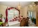 Traditional dining room with large window and decorative curtains at 5465 Chestnut Ridge Rd, Dade City, FL 33523