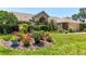 Beautiful single-story home with well-manicured lawn and colorful flower beds, creating a welcoming curb appeal at 5465 Chestnut Ridge Rd, Dade City, FL 33523
