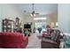 Well-lit living room with vaulted ceilings, fireplace, comfortable seating, and view of backyard pool at 5465 Chestnut Ridge Rd, Dade City, FL 33523