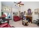 Spacious living room with high ceilings, a charming fireplace, comfortable seating, and plenty of natural light at 5465 Chestnut Ridge Rd, Dade City, FL 33523