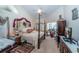 Comfortable main bedroom with a four-poster bed and a view of the pool at 5465 Chestnut Ridge Rd, Dade City, FL 33523