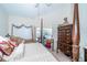 Main bedroom with traditional furniture, slider to the pool area and natural light at 5465 Chestnut Ridge Rd, Dade City, FL 33523