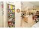 Well-stocked pantry and adjacent kitchen with stainless appliances and tile flooring at 5465 Chestnut Ridge Rd, Dade City, FL 33523