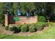 Elegant brick sign at the entrance to Whispering Oaks Estates Golf and Country Club, surrounded by manicured landscaping at 5465 Chestnut Ridge Rd, Dade City, FL 33523