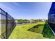 This property overlooks a tranquil lake with fountain views from the backyard's black metal fence at 5920 Silver Palm Blvd, Bradenton, FL 34211