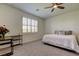 Bright bedroom featuring a ceiling fan, a comfortable bed, and a window with plantation shutters at 5920 Silver Palm Blvd, Bradenton, FL 34211