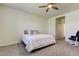 Cozy bedroom with a ceiling fan, plush carpet, and a view into the hallway at 5920 Silver Palm Blvd, Bradenton, FL 34211
