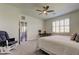 Spacious bedroom featuring plantation shutters, a ceiling fan, and easy access to the bathroom and walk-in closet at 5920 Silver Palm Blvd, Bradenton, FL 34211