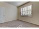 Neutral bedroom offers carpet, white walls, and plantation shutters on the window at 5920 Silver Palm Blvd, Bradenton, FL 34211