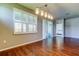 The dining room features wood floors, a modern light fixture and a large window with shutters at 5920 Silver Palm Blvd, Bradenton, FL 34211