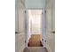 Hallway with multiple doorways leading to a bathroom and a closet space, showcasing the home's functional layout at 5920 Silver Palm Blvd, Bradenton, FL 34211