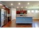 Spacious kitchen with a center island, stainless steel appliances, and dark wood cabinetry at 5920 Silver Palm Blvd, Bradenton, FL 34211