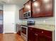 Modern kitchen features stainless steel appliances, granite countertops, and dark wood cabinets at 5920 Silver Palm Blvd, Bradenton, FL 34211