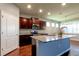 Well-lit kitchen featuring a large island, granite countertops, and stainless steel appliances at 5920 Silver Palm Blvd, Bradenton, FL 34211