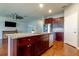 Kitchen with a granite countertop kitchen island, stainless steel dishwasher, and ceiling fan at 5920 Silver Palm Blvd, Bradenton, FL 34211