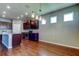 Bright kitchen features dark cabinetry, stainless steel appliances, an island, and wood flooring at 5920 Silver Palm Blvd, Bradenton, FL 34211