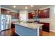 Modern kitchen with stainless steel appliances, granite countertops, and dark wood cabinets at 5920 Silver Palm Blvd, Bradenton, FL 34211